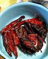 dry chile pepper in blue bowl