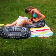 girl on a lifebuoy on the green grass lawn