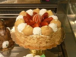 cake with cream puffs and fruits on it