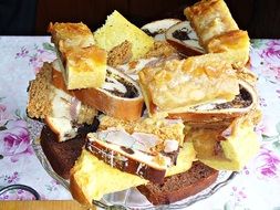 cheesecake, pastries with poppy seeds and muffins on a plate