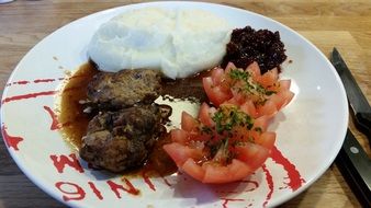 delicous Mashed potatoes,tomatoes and meat on the plate