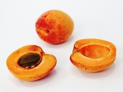 two apricot halves and ripe apricot