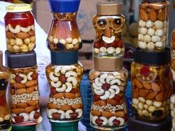 Beatiful patterns made of nuts in the glass jars