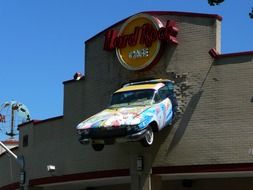 car mounted in facade of hard rock cafe