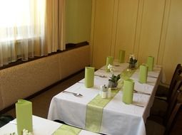 green and white clothed tables in restaurant