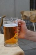beer in a mug in hand