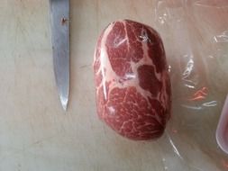 raw beef and knife on cutboard