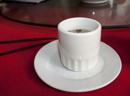 white cup of tea with a saucer in a cafe