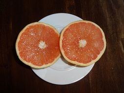 two pieces of blood orange on the white plate