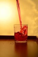 splash glass liquid pouring red color alcohol drink