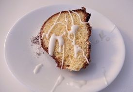 orange cake with icing sugar on white plate