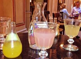 multicolored drinks in glass goblets on the table