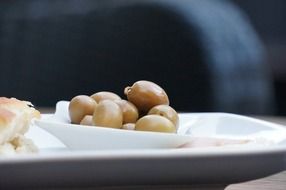 pile of green olives on plate as starter