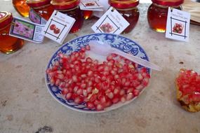 pomegranate seeds in a ceramic bowl