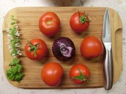 tomatoes and onion and knife and basil