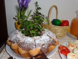 easter baba decorated with green branches on holiday table