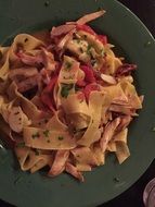 italian brown pasta in dark plates