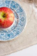 red apple on a ceramic plate