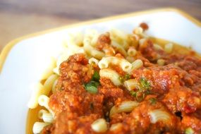 pasta bolognese on a white plate