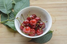 cherries in white dish