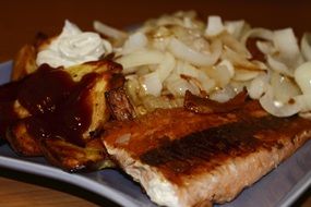 fried salmon on a plate close-up