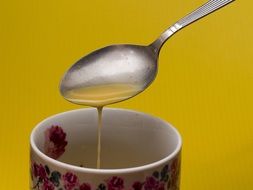 spoon with tea in a cup