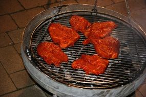 grilling meat steaks on a barbecue