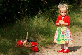 little girl in colorful dress with basket