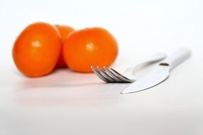 cutlery on a background of mandarines