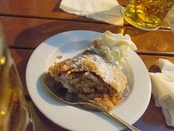 food in a white plate and beer