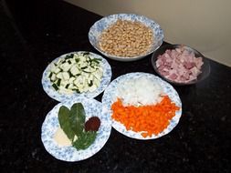 raw vegetables, spices, beans and meat for soup