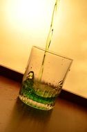 splash of green liquid in glass