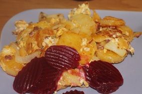 fried potatoes and boiled beets on a plate