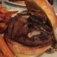 burger with onion in bun close-up