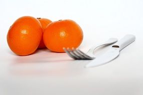 fork, knife and tangerines