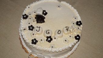 cake with white icing and chocolate flowers