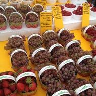 Blue grapes and strawberries in the market