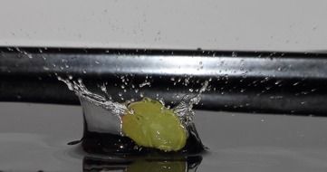 grape berry falls into the water