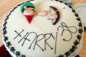 Colorful decorated cake with the words "Harry 38"