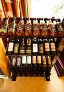 bottles of whiskey and wine on a wooden desk