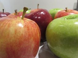 Colorful shiny apples on the table