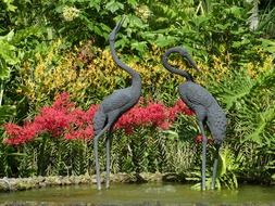 sculpture of two herons in a park in singapore