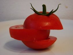 sliced red tomato on a white surface