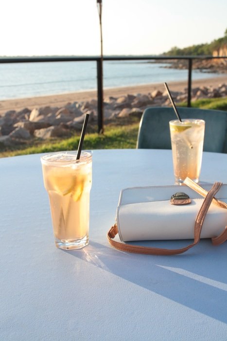 beverages are on table near the ocean