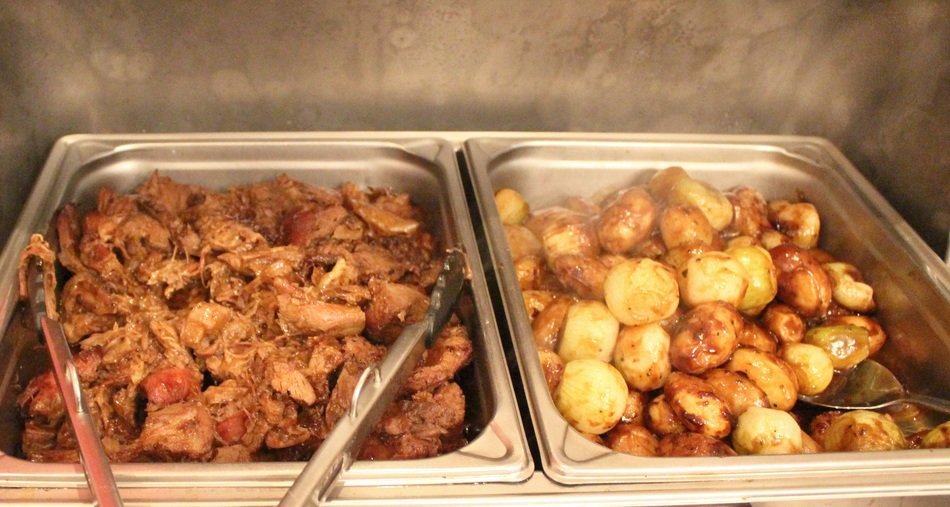 Meat in metal containers on the buffet