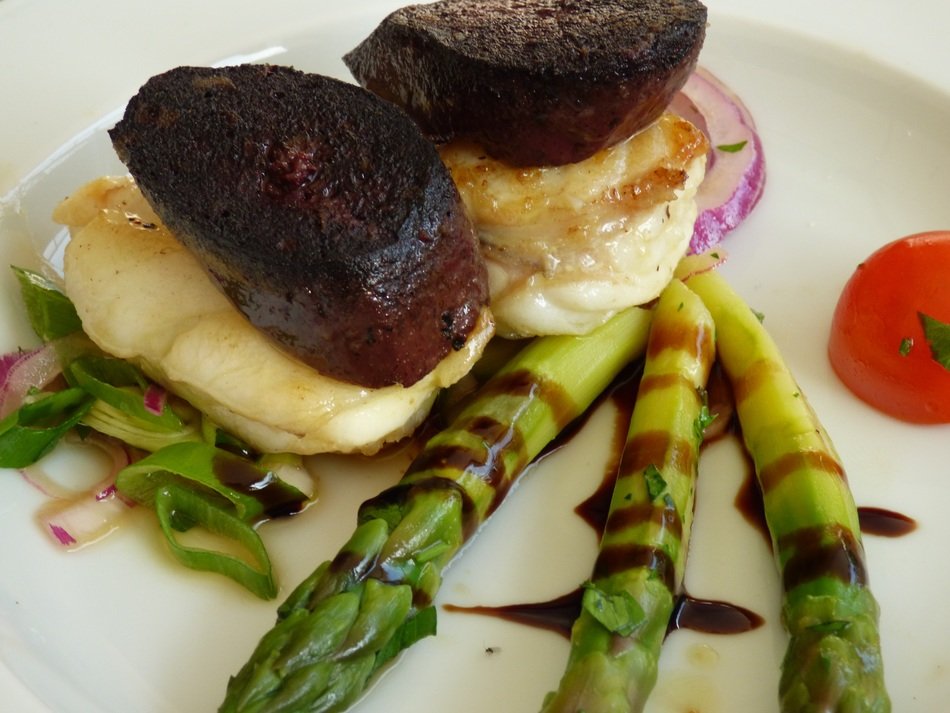 monkfish with red sausage near asparagus