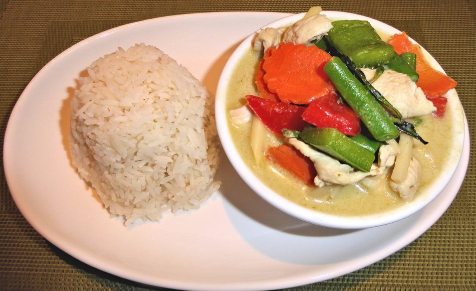 rice with curry chicken and vegetables plate
