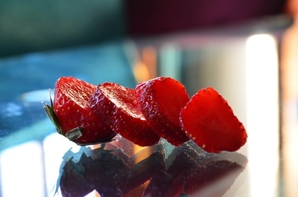 sliced strawberries on a glass table