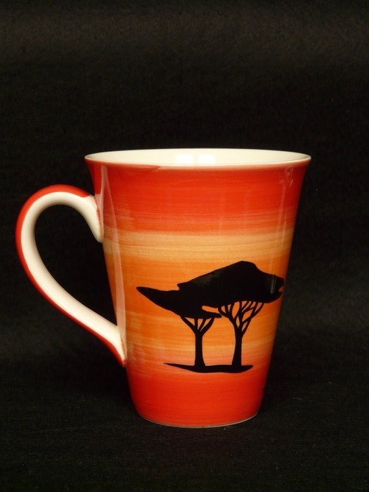 cup with the african landscape on black background