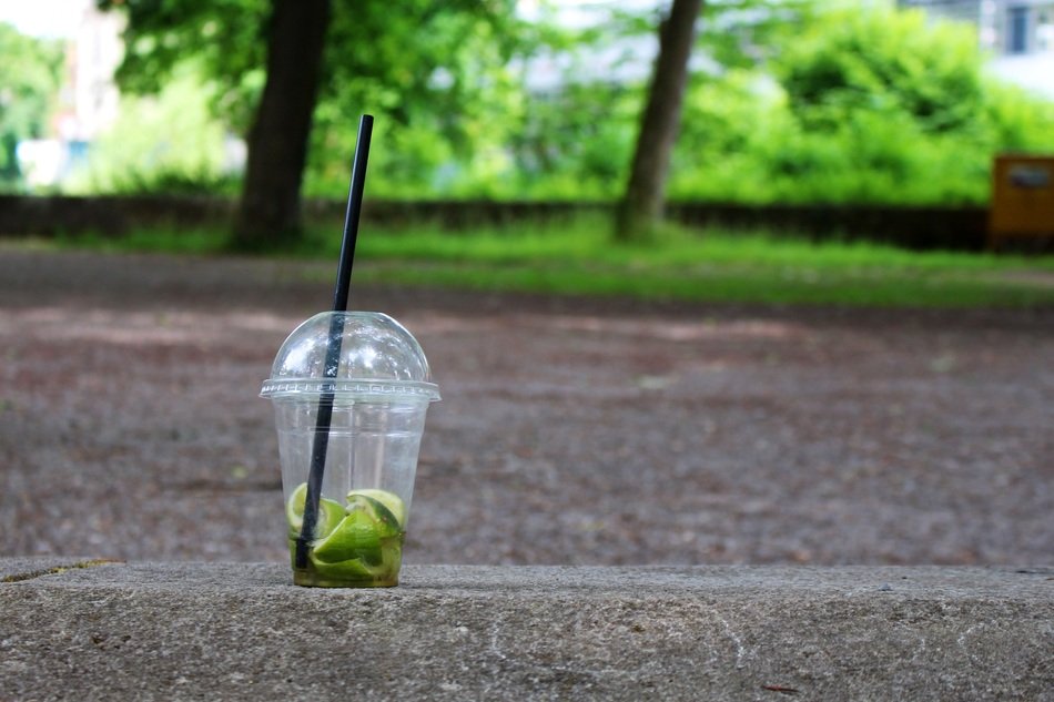 plastic cup with rests of smoothies on the road